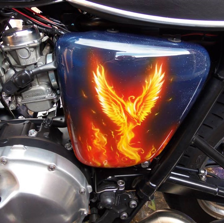 Airbrushed Painting of a Triumph Motorbike with Flame Design, Pheonix on Side Panel Mounted on bike